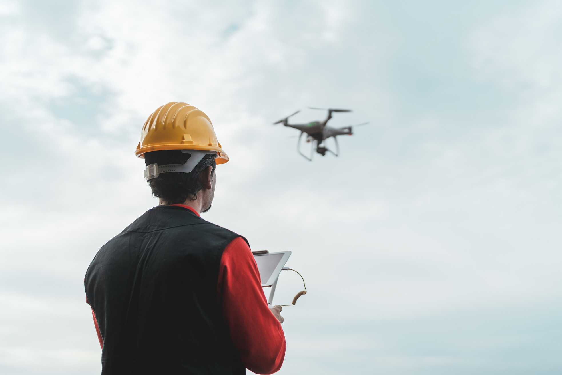 Engineer Monitoring Construction Site with Drone